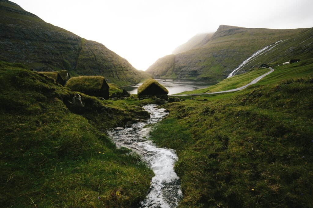 Grass-roofed houses and a stream in Saksun, Faroe Islands